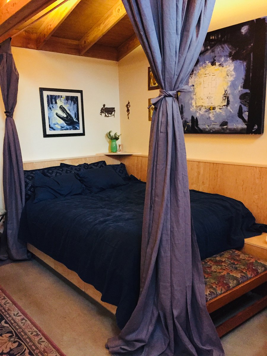 Curtained queen bed w reading lights, and lower storage drawers
