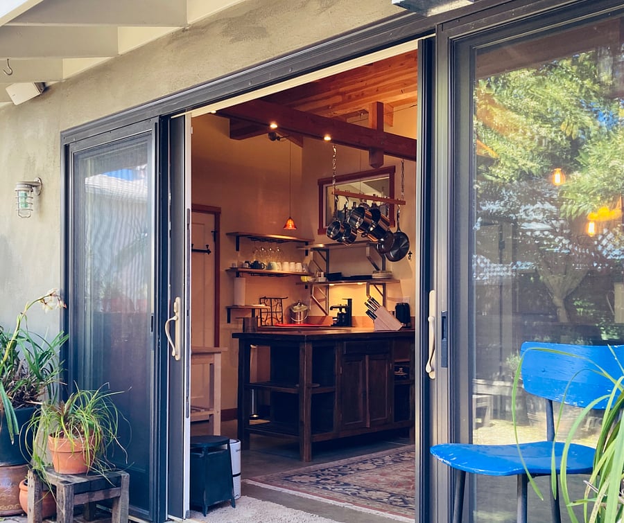 Wide sliding entry doors, screened and curtained
