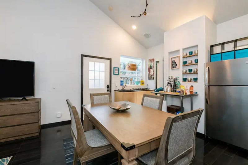Large dining table that doubles as a desk and seating area.