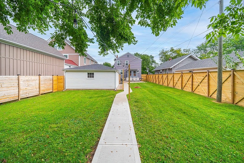 Portion of the backyard behind the front house. You'll enter this area through a designated gate entrance.