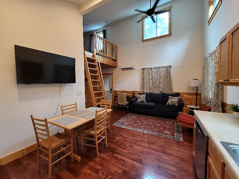 View from corner of the kitchen to front door. You can see the ladder and loft.