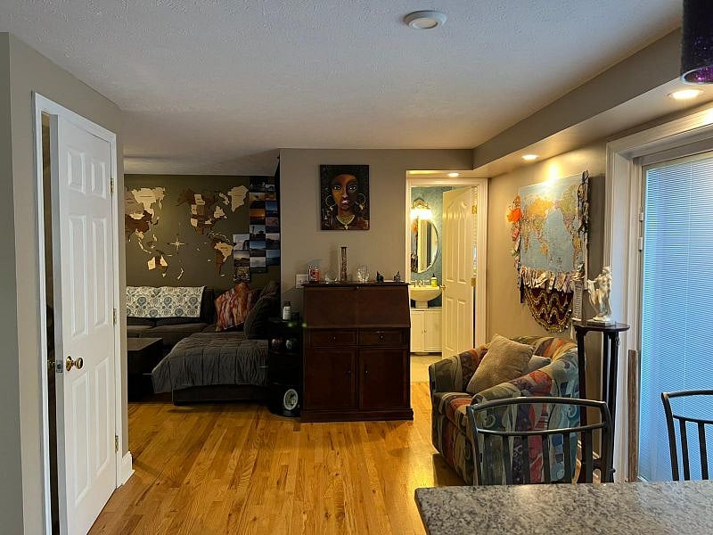 Open floor design, bathroom, living room, and basement door