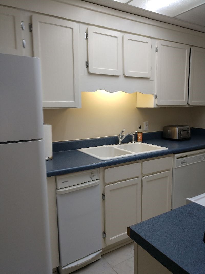 sink and fridge, across from stove in galley kitchen