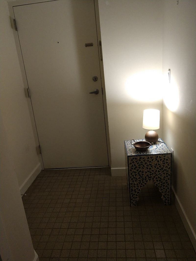 front hallway showing door to unit