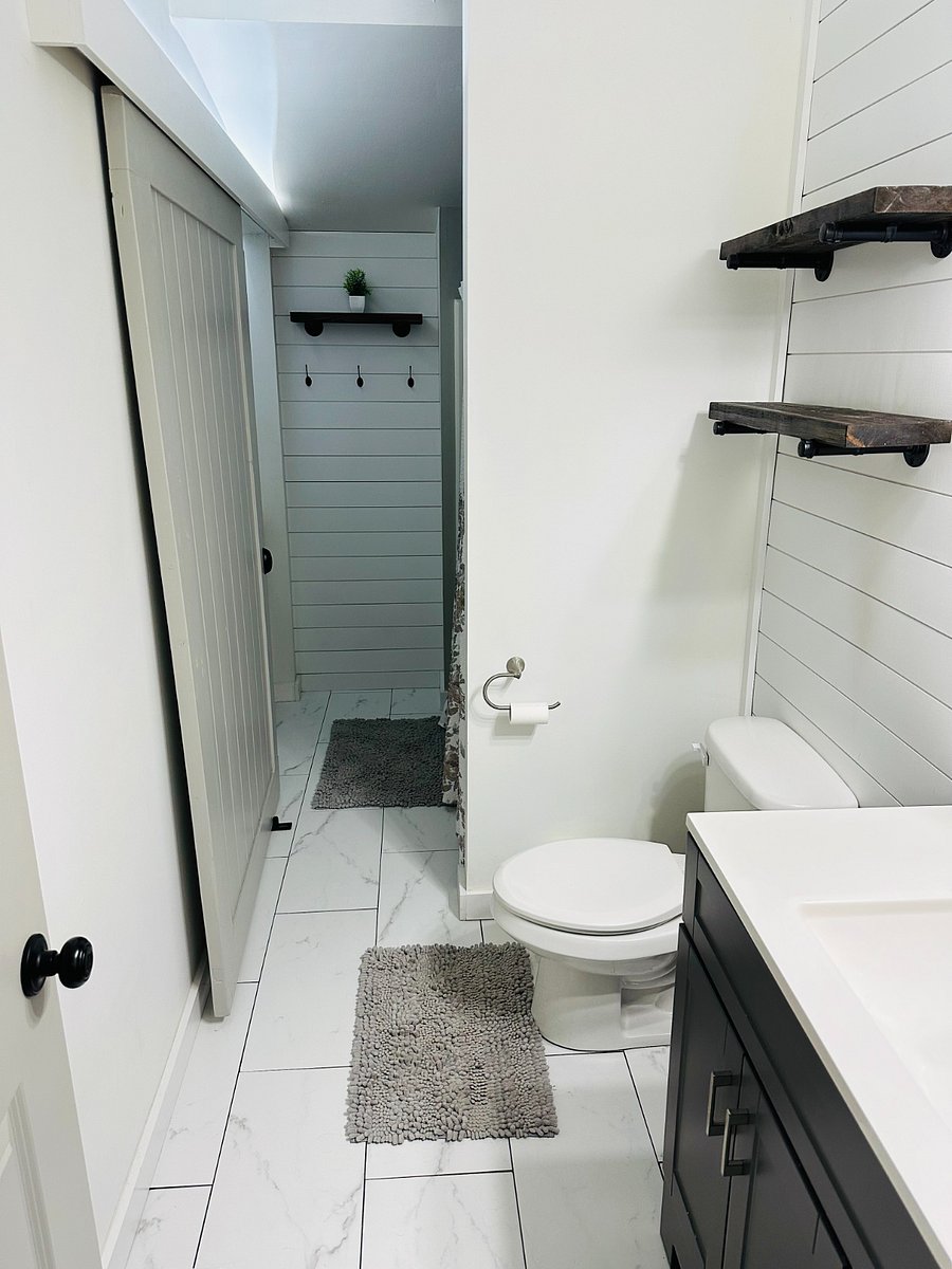 Bathroom with washer / dryer unit on the left. Bathroom has a full tub