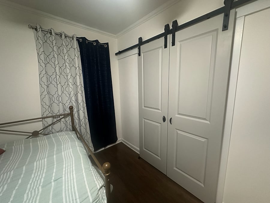 Closet in room with full-sized bed