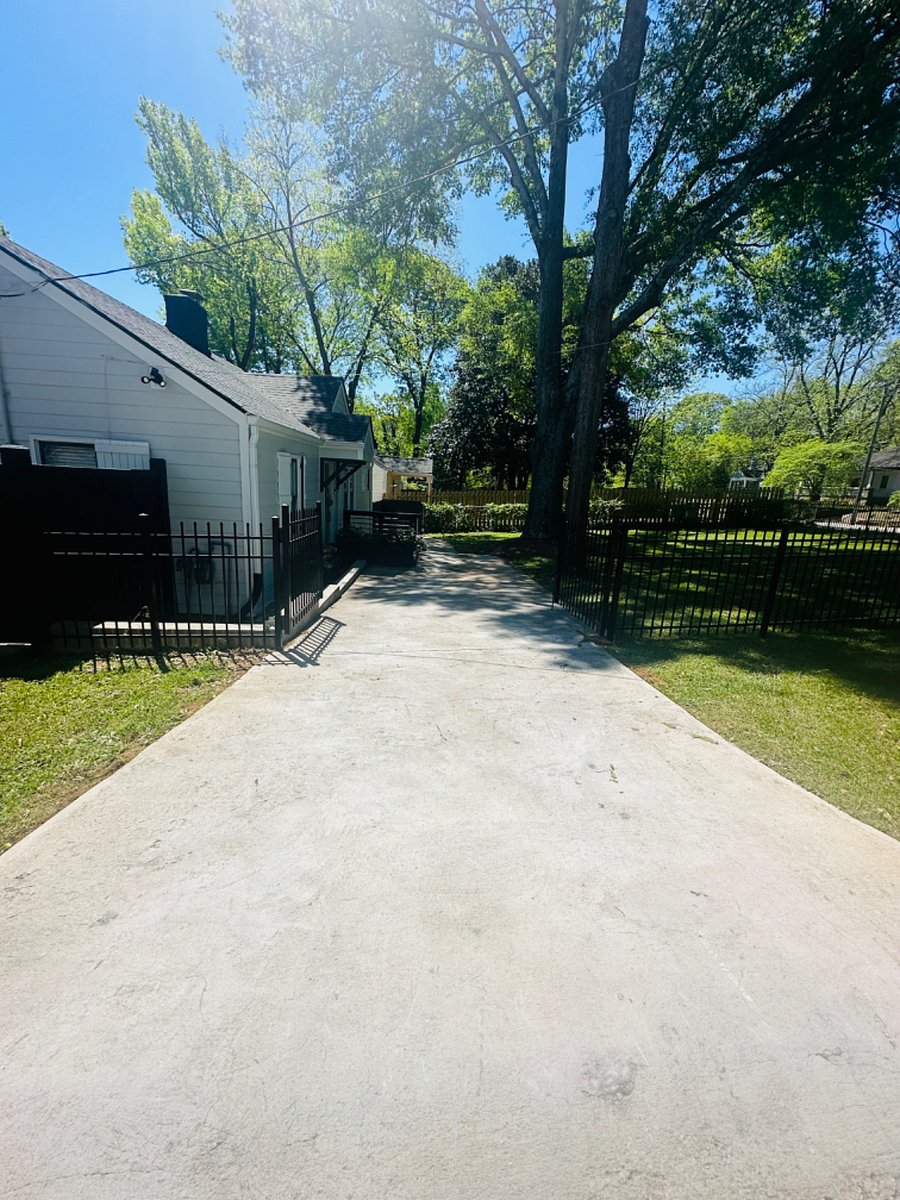 Driveway parking fits one car (with gate closed) or two cars (with gate open). Additional parking is available in gated backyard.