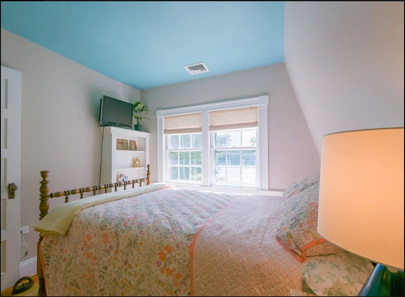 Bedroom 1 with double bed and view of canal