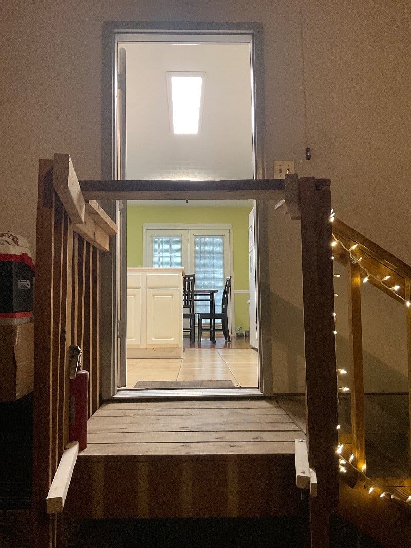 Stairs from garage into kitchen. Side of stairs opens up to easily set groceries, suitcase, etc. on to easily move into house. This is much easier than carrying these things up the stairs.