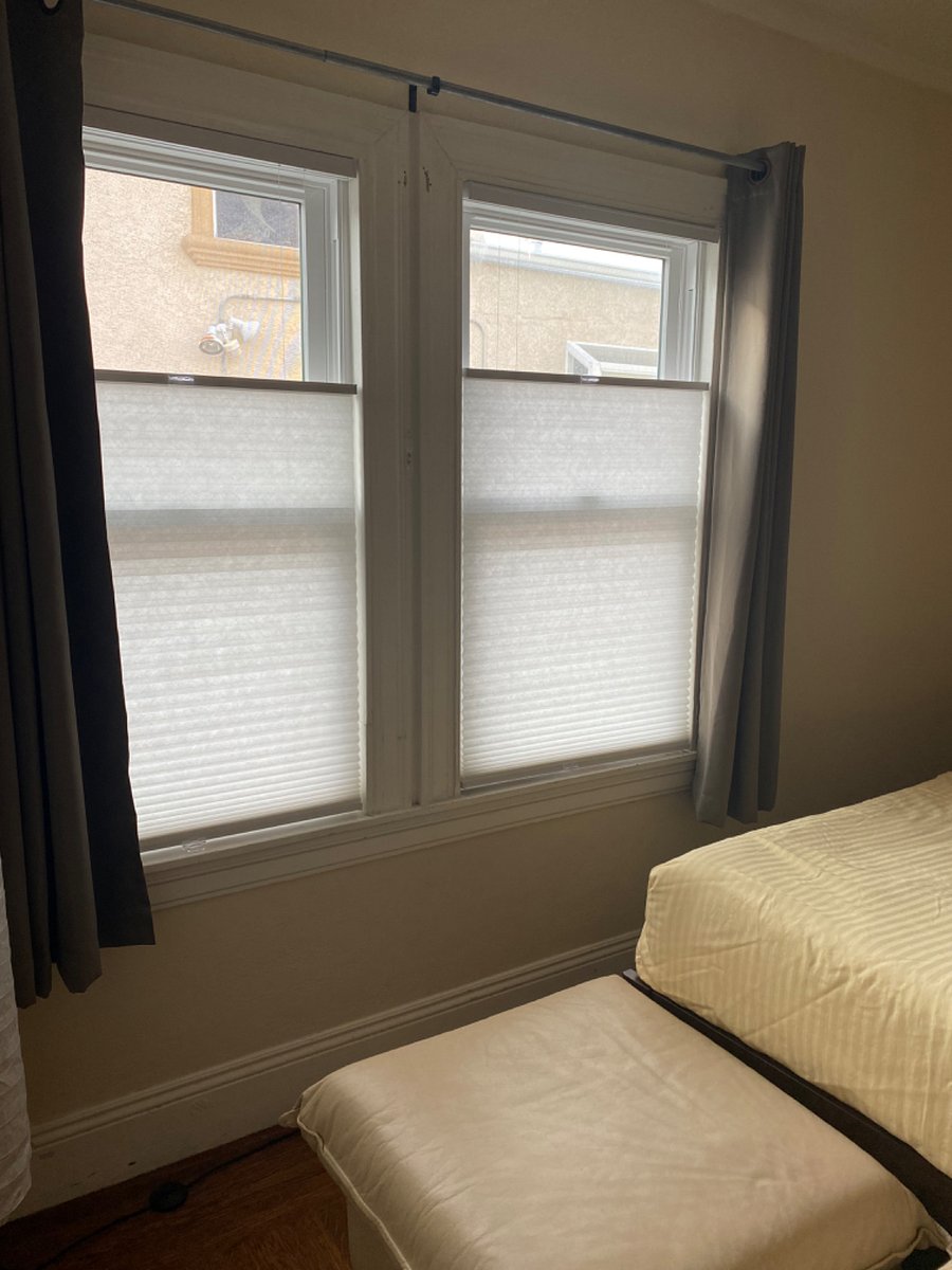 New double panel windows w/ blackout curtains and top down, bottom up cellular shades