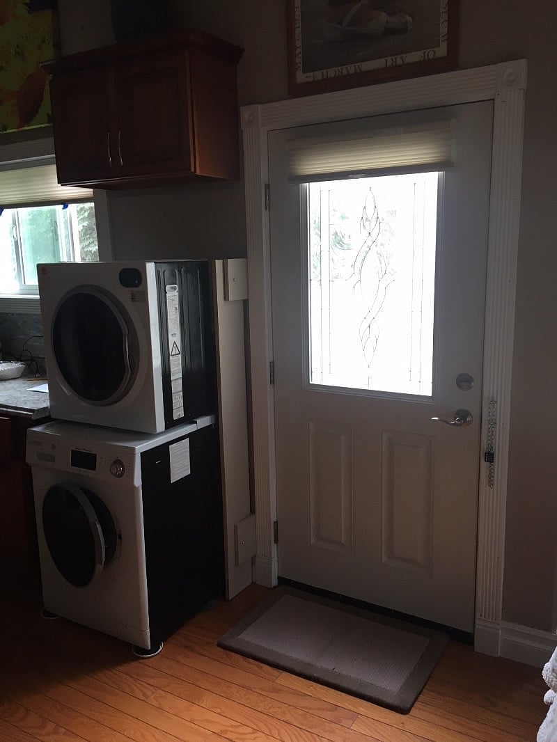 This photo shows the private entry door with the staked washer/dryer.