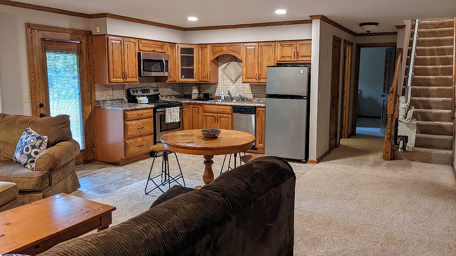 Suite living room and kitchen (shared by bedrooms 1 & 2), showing stairs up to the main level!