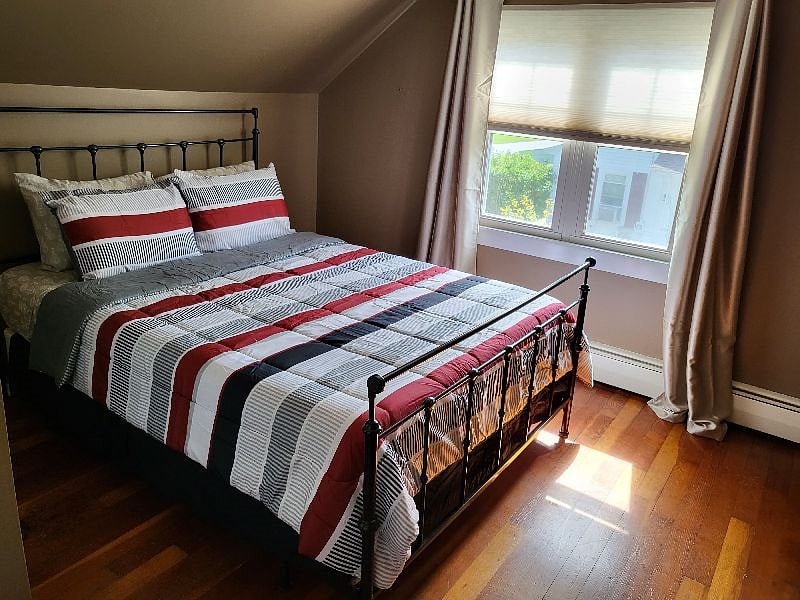 Current photo of Bedroom 1 with a queen bed. 