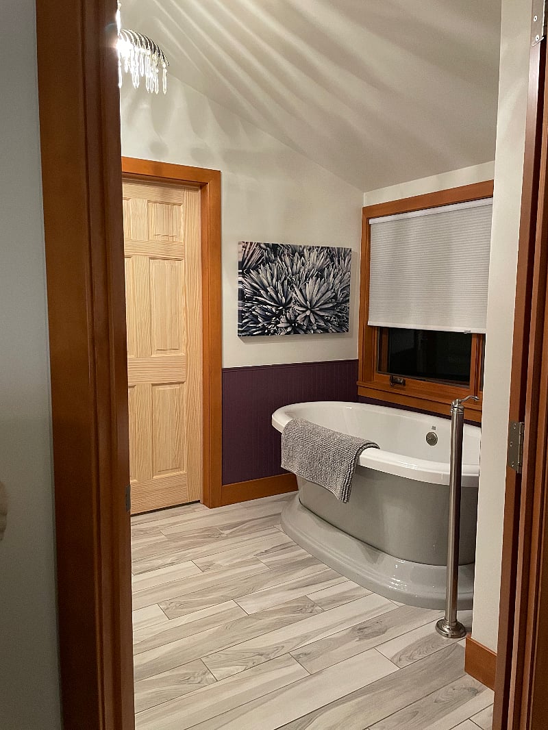 Our luxurious en-suite includes a soaker tub, a walk-in shower with two rain heads and a bench, a lighted mirror.
