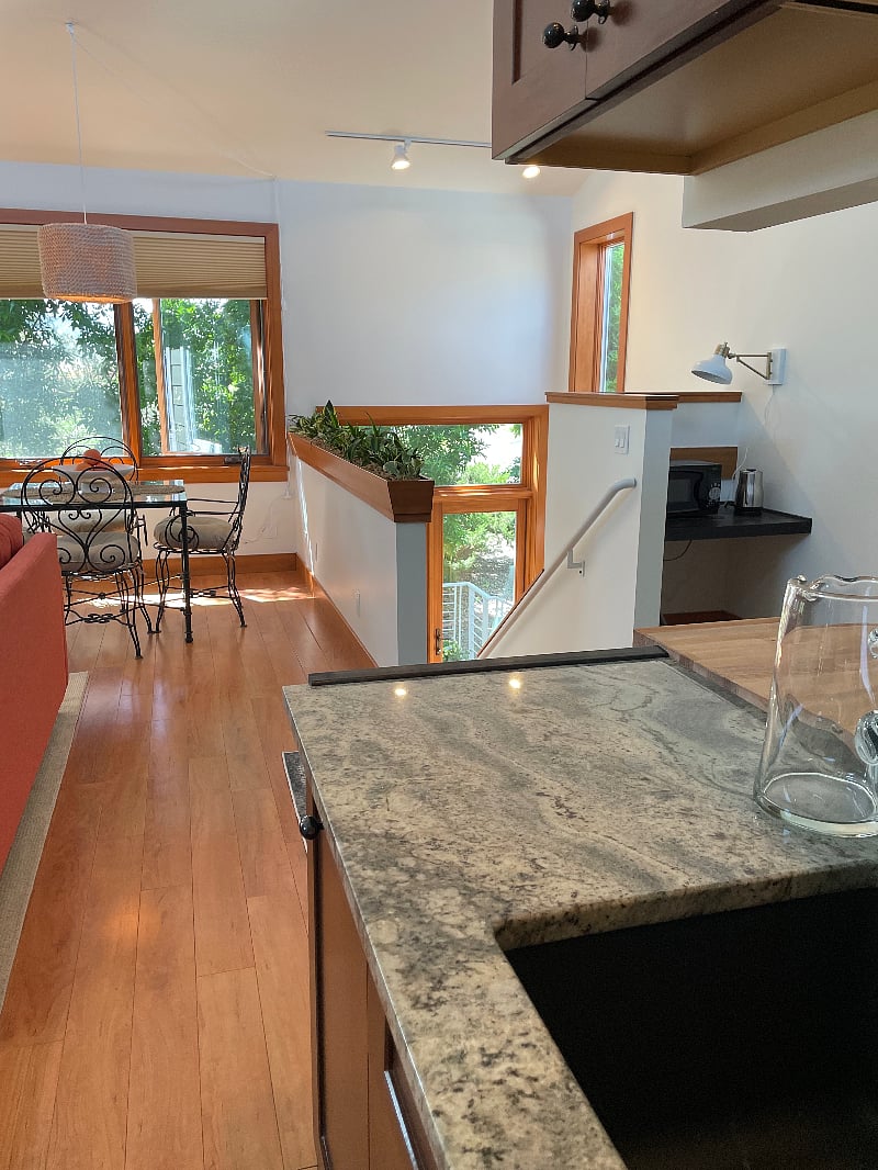 Your stairs up lead to the open-air concept room with a large kitchenette, dining, and living room.