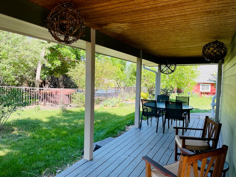 North wrap-around porch is your own outdoor dining area. It has views to the hot-tub and pool and is lit by twinkle lights in the evening.