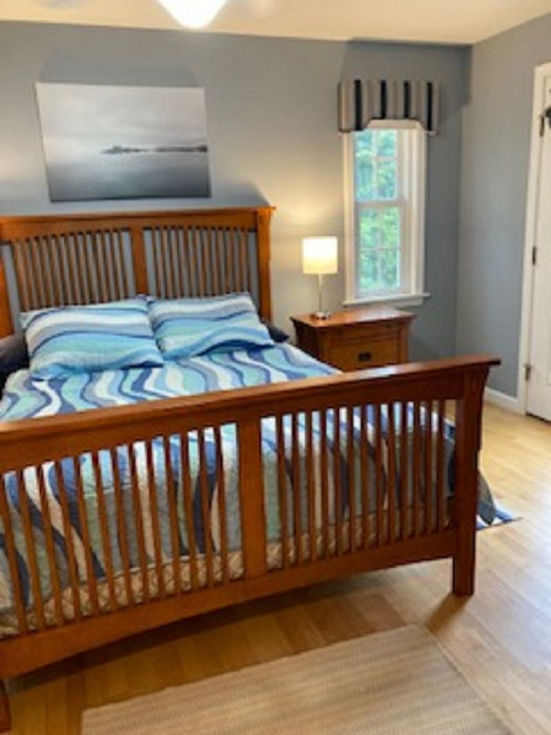 First floor bedroom, has a door out to the deck, queen size bed, attached full bath and walk in closet