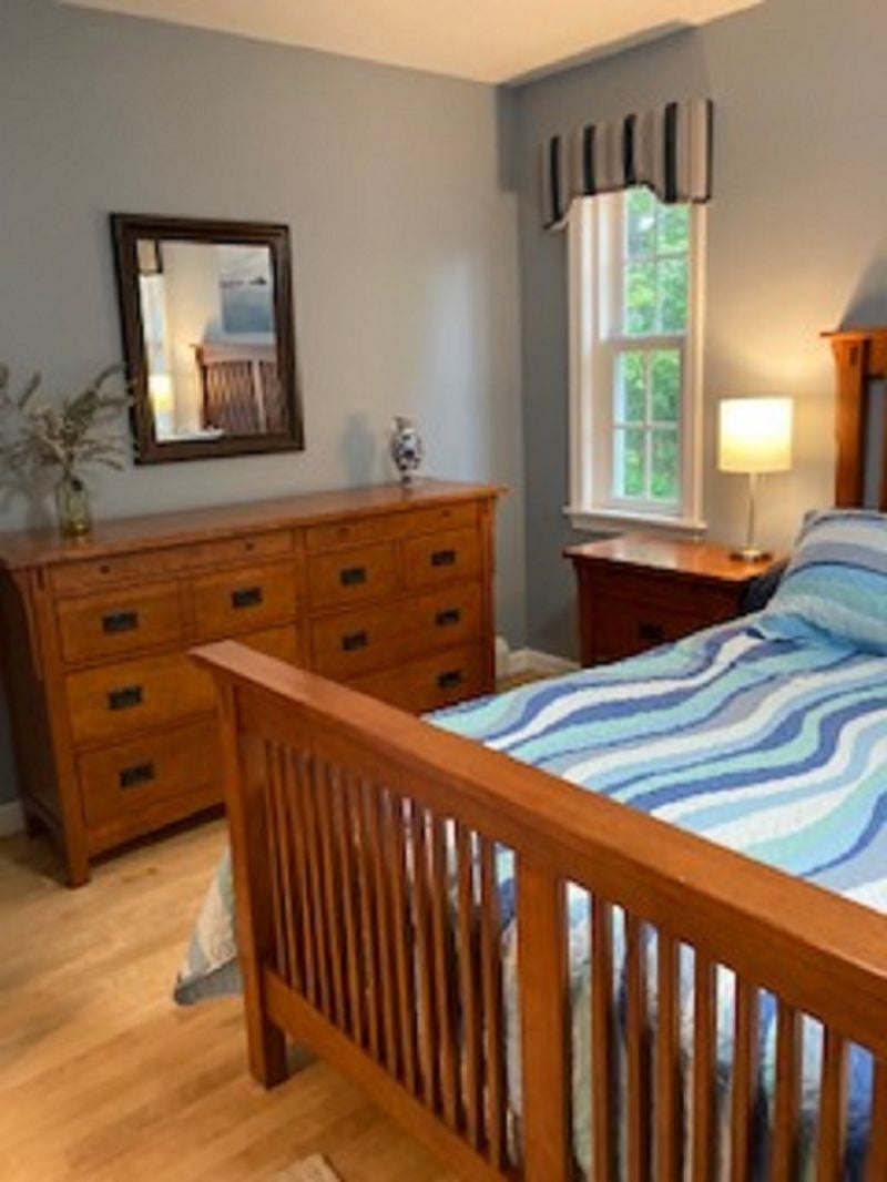 First floor bedroom, has a door out to the deck, queen size bed, attached full bath and walk in closet