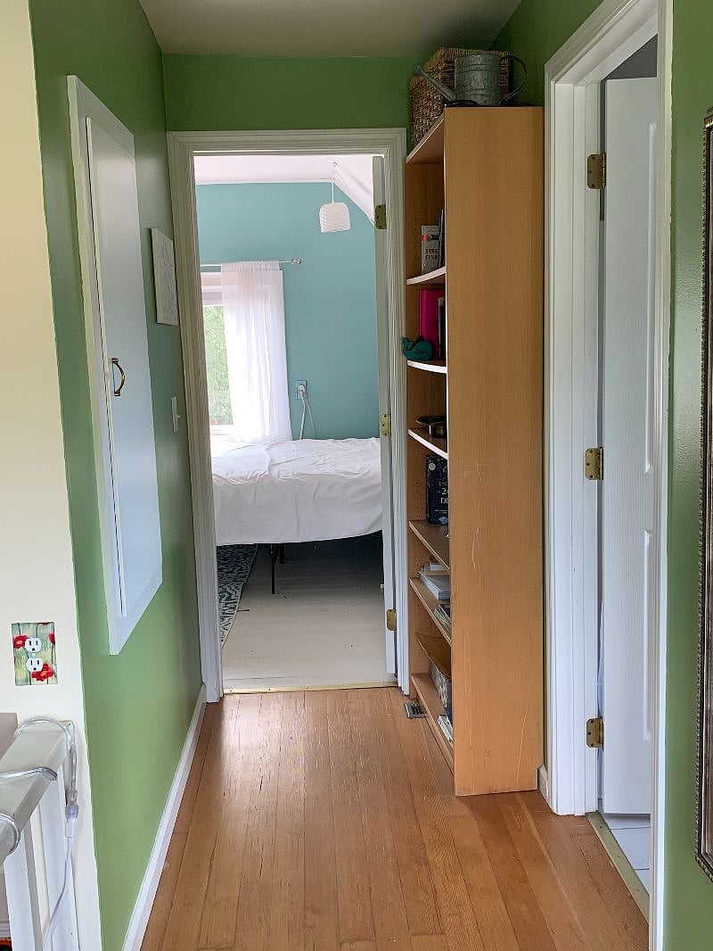 Hallway leading to bedroom, bathroom on right