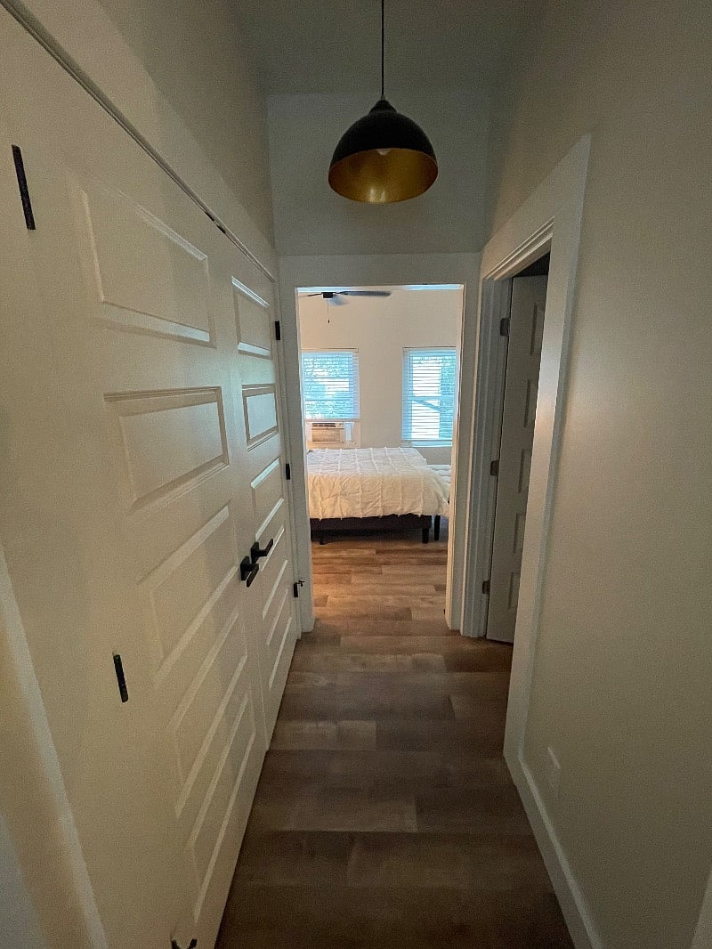 Hallway from living room into bathroom and bedroom