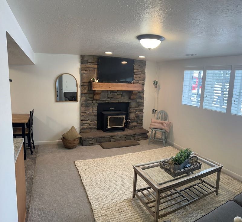 Connected kitchen with 42" Roku Smart TV and wood stove burner.