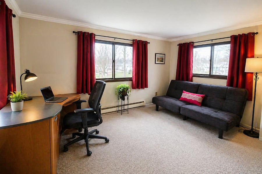 Sun room with office desk and futon, can be used as third bedroom