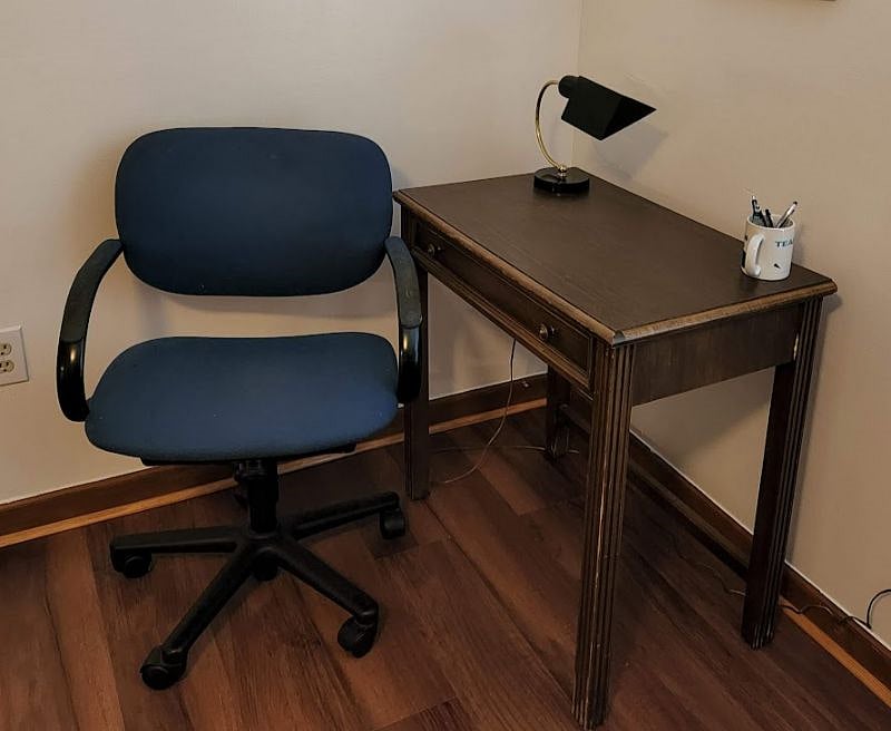 Desk with drawer and comfortable chair.
