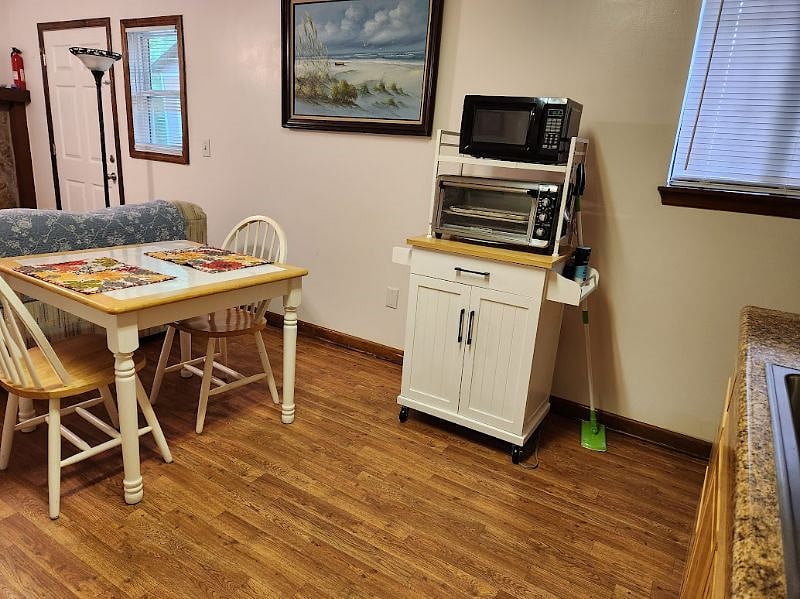 Utility cart on wheels with toaster-oven and microwave.