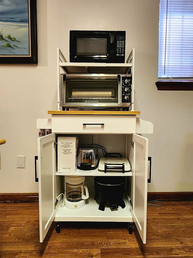 Box of toaster-oven cookware, toaster, hotplate, coffee-maker, electric Dutch oven.