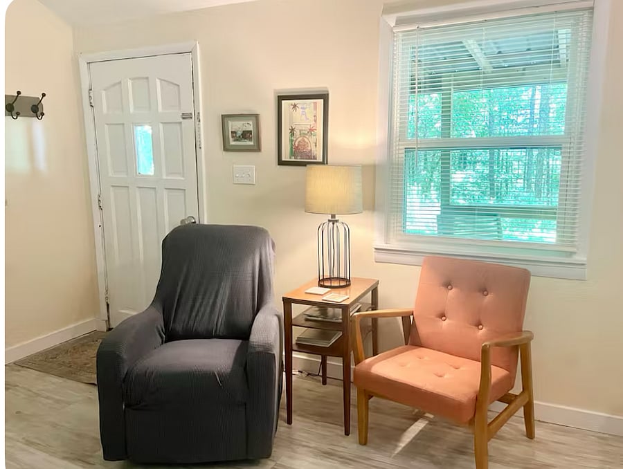The orange chair is now in the bedroom and there is another recliner.