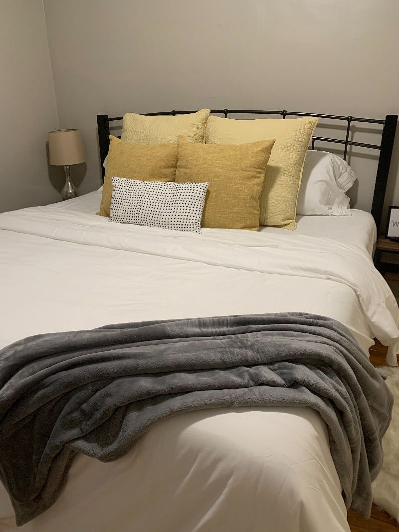 King Size 12" bed with luxury linens. Wall mounted TV, blackout curtains and lots of storage in closet
