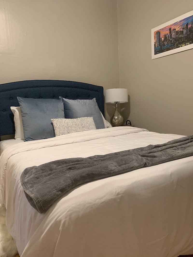 Queen Size 12" bed with luxury linens. Wall mounted TV, blackout curtains and lots of storage in closet