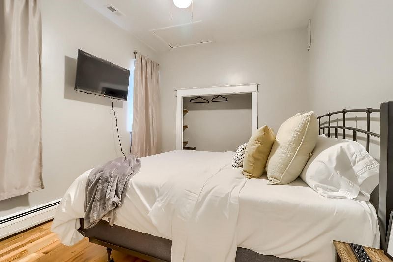 King Bedroom with 40" smart TV, blackout curtains and shelving in closet for storage