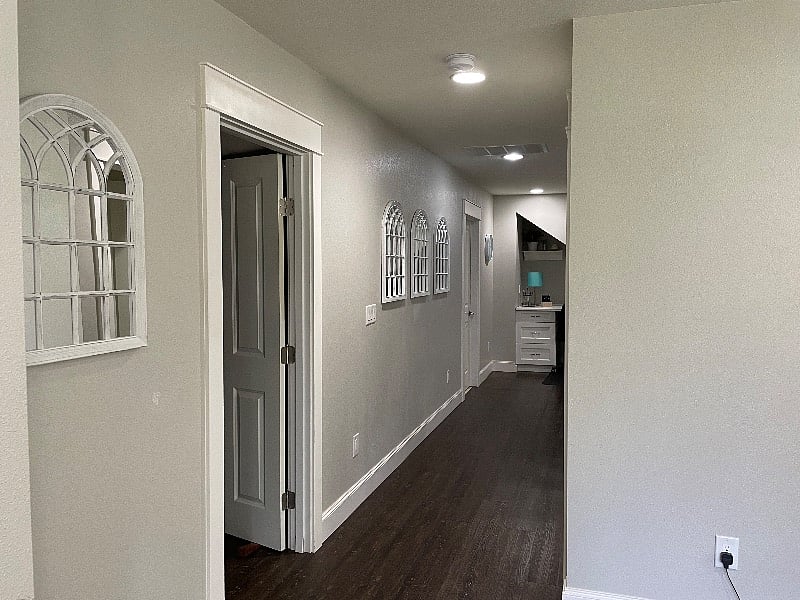 Bedroom door & hallway to the kitchen. The bathroom door is directly across from the bedroom. There is an additional linen closet (not pictured) in this hallway.