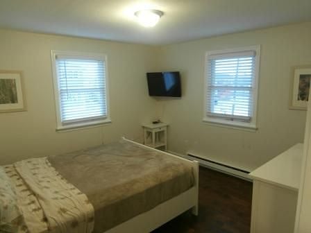 1st bedroom - queen bed, tv, bureau, and closet.