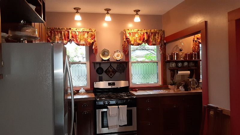 kitchen has gas stove, many cabinets and large refrigerator to share