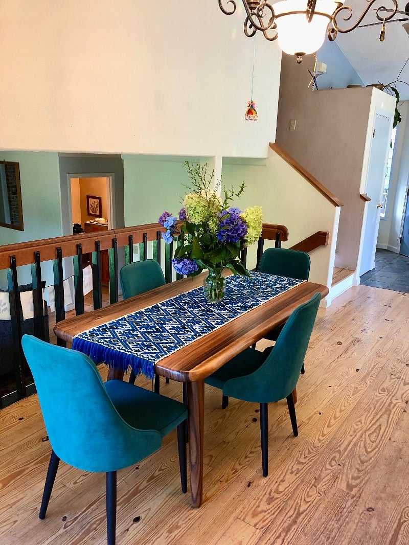 Open dining room, overlooking the sunken living room with view of back yard.
