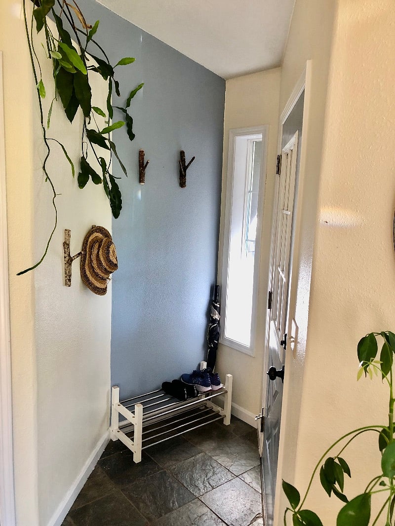 Front door, coat closet, handmade coat hooks on the wall