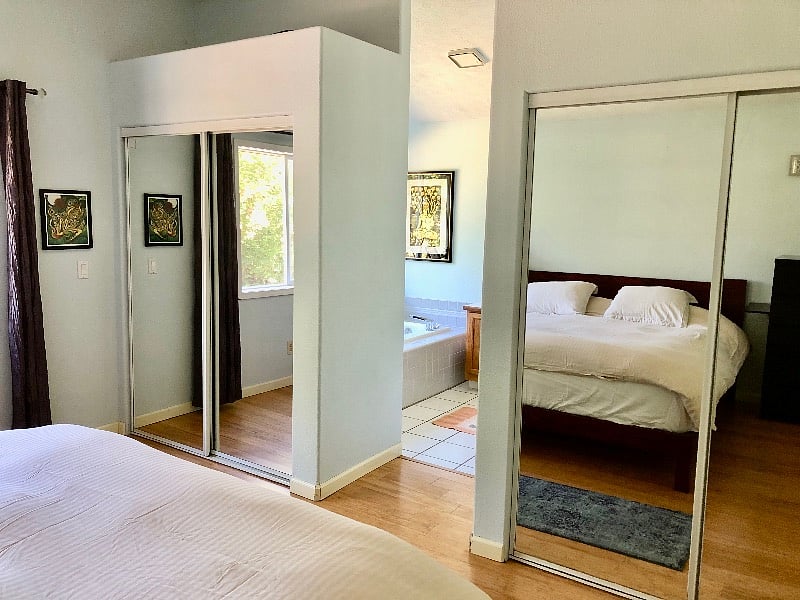 Primary Bedroom, opens into large private bath. Double closets, looks out onto the scenic backyard and forest. Many bird songs are heard from this room!