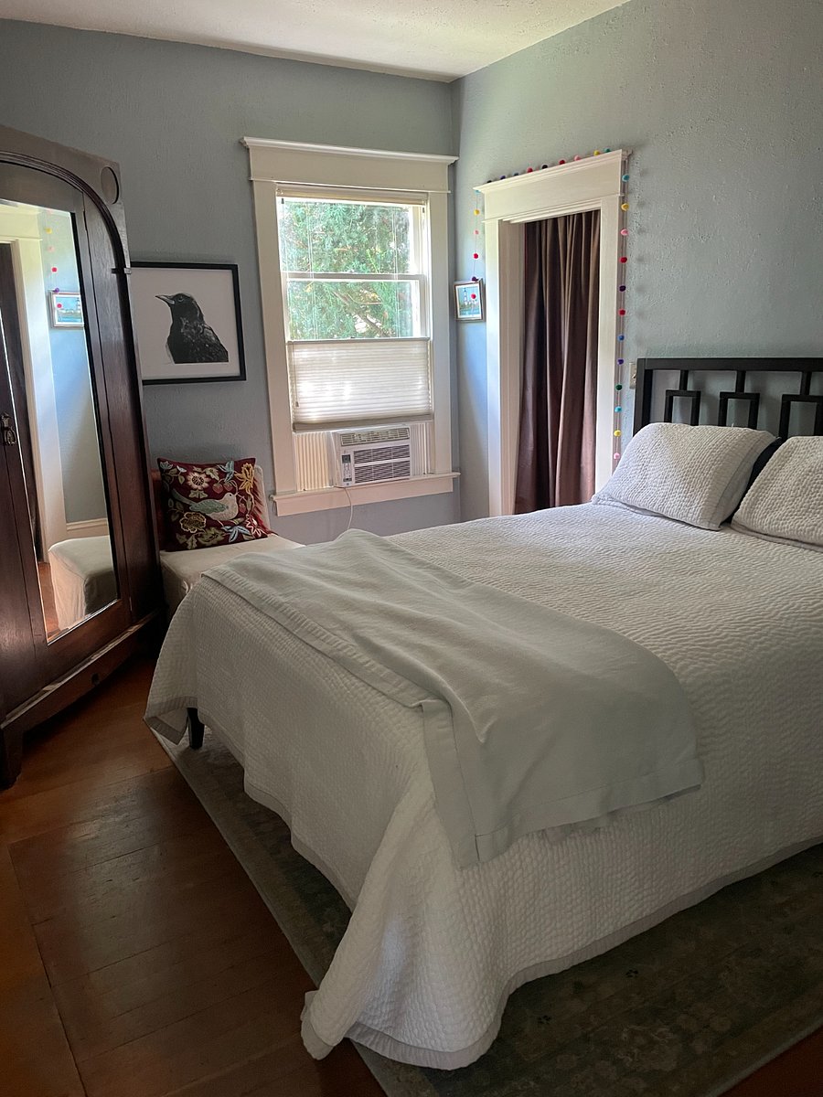 Bedroom with queen sized bed. Saatva mattress. Lovely armoire. Small closet behind the brown silk curtain. 3-drawer dressser