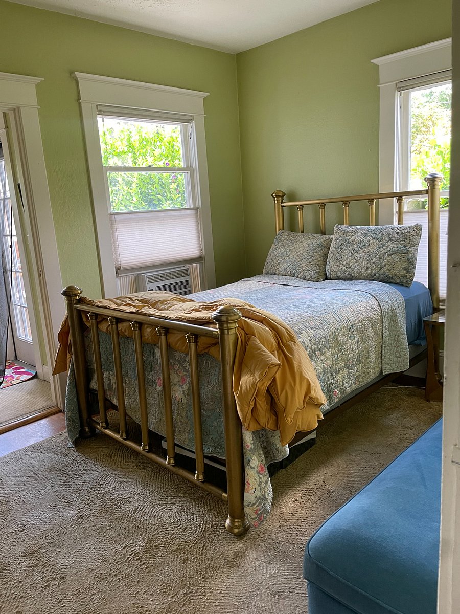 Bedroom with full sized high quality mattress on brass bed. Higher off the ground than average bed. Access to small office and backdoor to patio