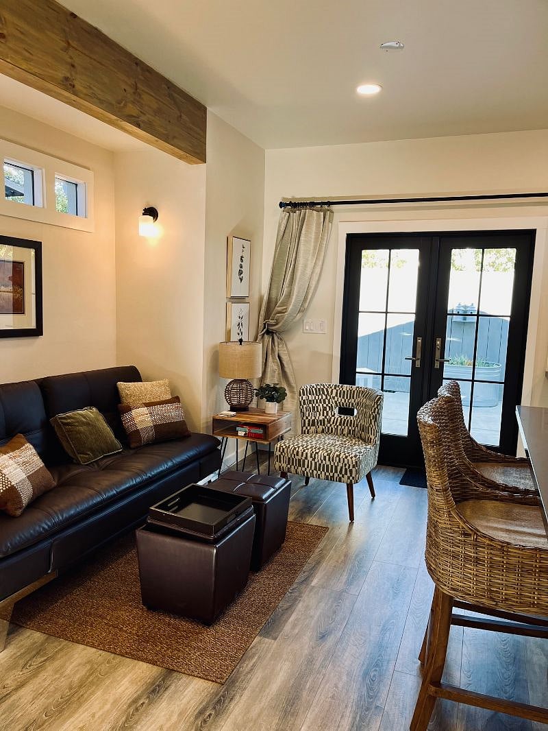 Living room area with Leather Sofa Bed, ottomans and chair 