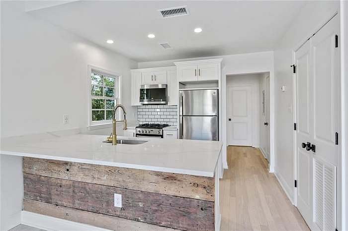 Fully equiped kitchen with brand new stainless steel appliances and counter sized island