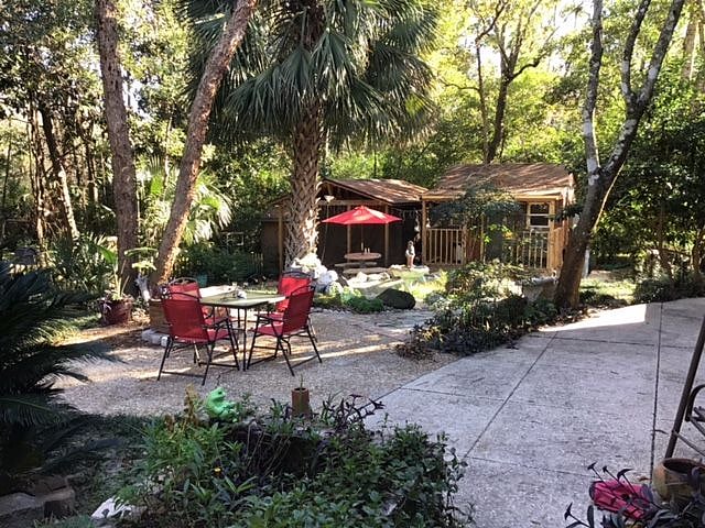 Ground-level view in rear, fenced yard. Property goes to creek in back!