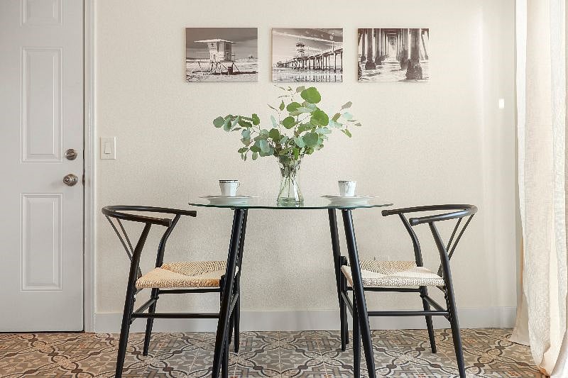 Indulge in a cozy moment with a steaming cup of coffee at our quaint cafe table - the perfect spot for intimate conversations.