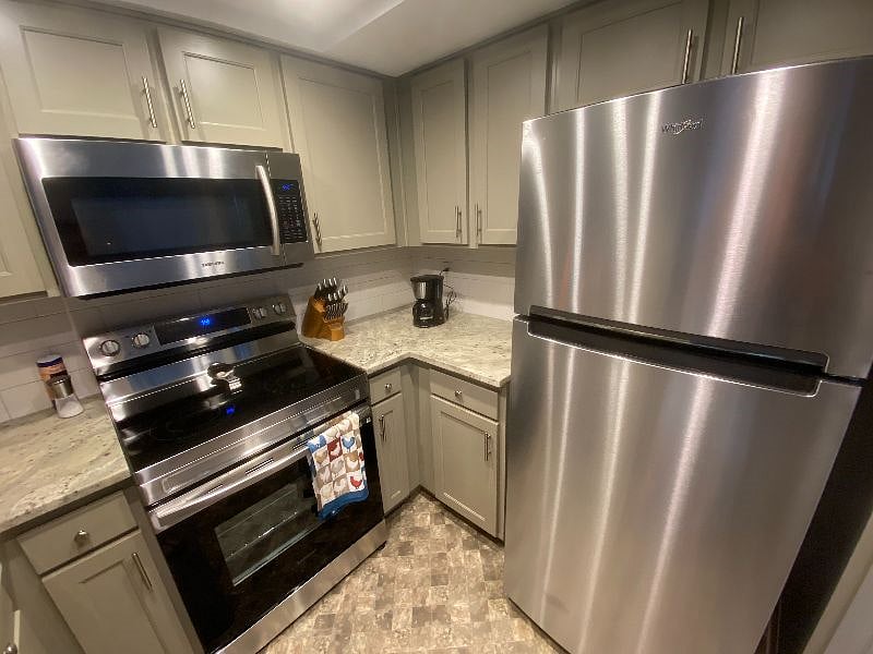 Kitchen with new oven and refrigerator.