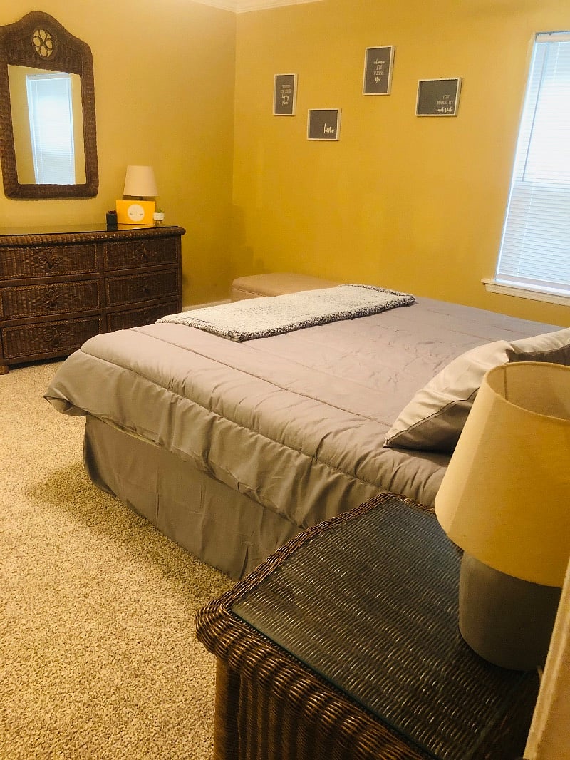 Master Bedroom with a king size bed, open bathroom and open master closet and a door that leads to the MAN CAVE/ Theatre room.