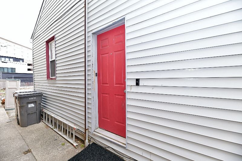 Your door is on the side of the building on the left!
