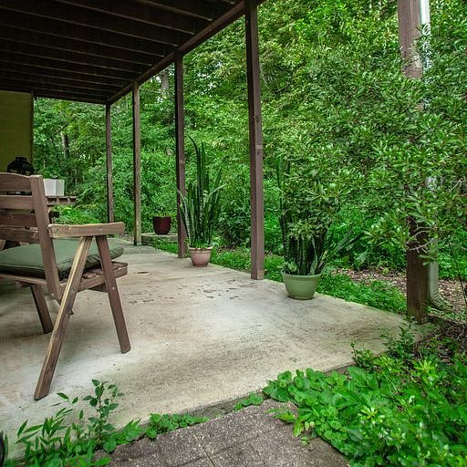 View of wooded area and walking trail from spacious porch