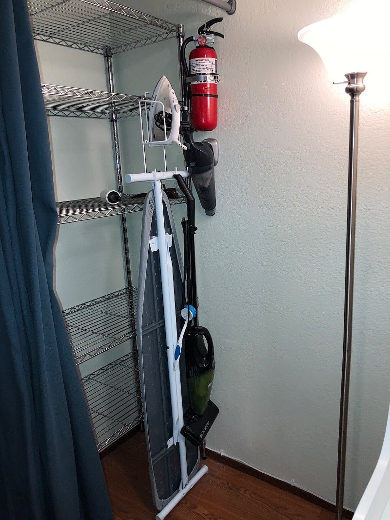 Ironing board, iron vacuums in closet and dining/office area